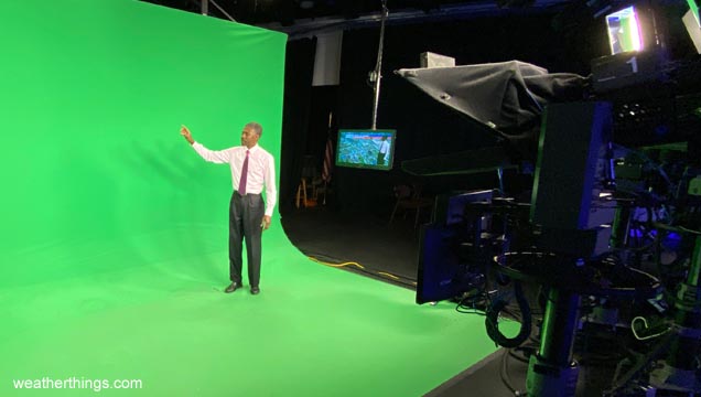 weathercaster in front of green screen